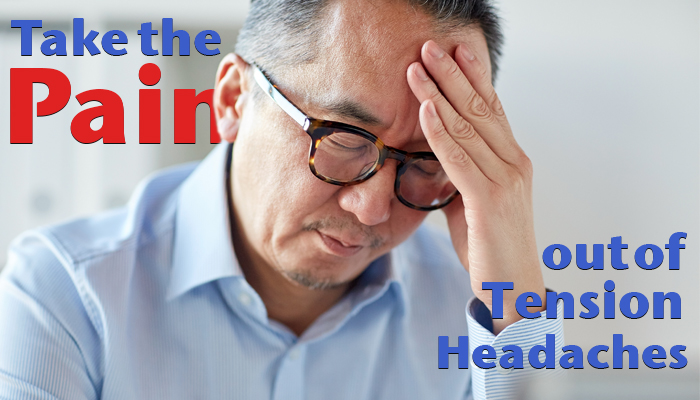 Man holding his head suffering from a tension headache.