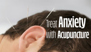 Image of a man's ear with acupuncture needles