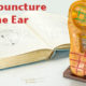 Acupuncture needles, text book and plastic ear